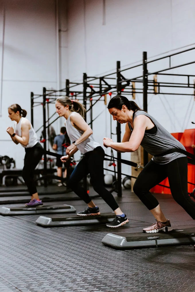 Group of women participating in a step cardio workout at Elite Edge Fitness, Chamblee, GA