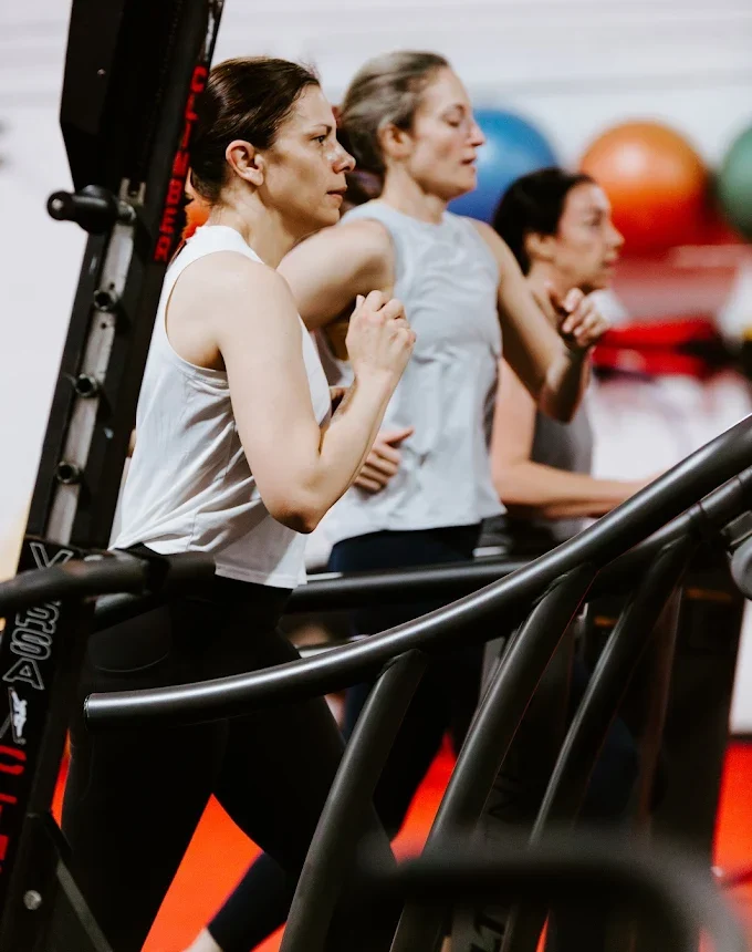 Women training on VersaClimbers during a group cardio class at Elite Edge Fitness in Chamblee, GA