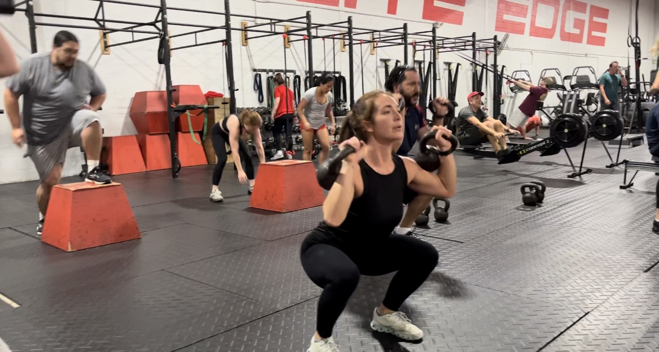 Woman doing squats during functional fitness class at Elite Edge Fitness in Atlanta